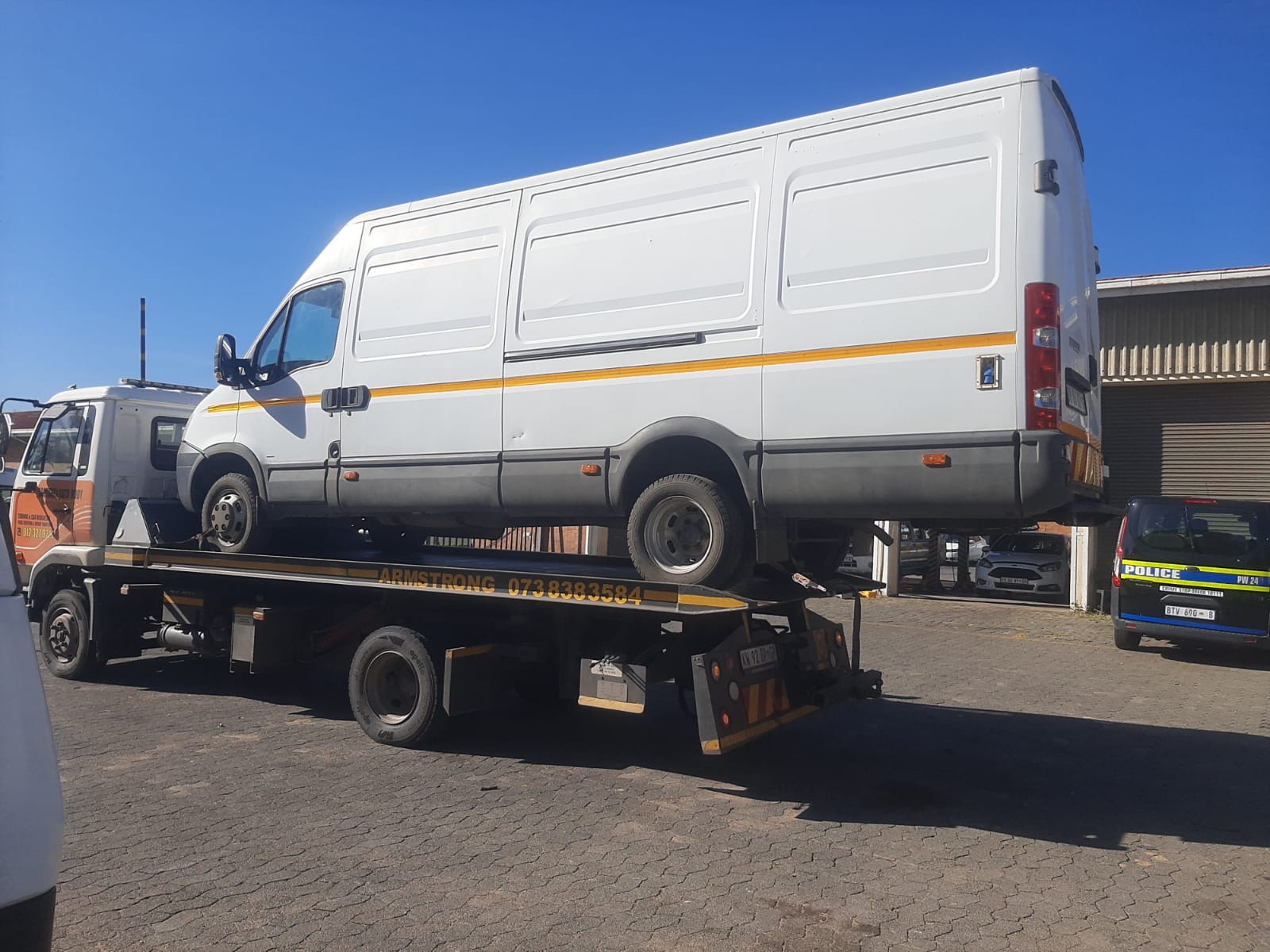 White Iveco panel van loaded on the Armstrong Towing truck